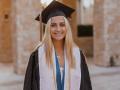 Abbey Serio, smiling and wearing her cap and gown