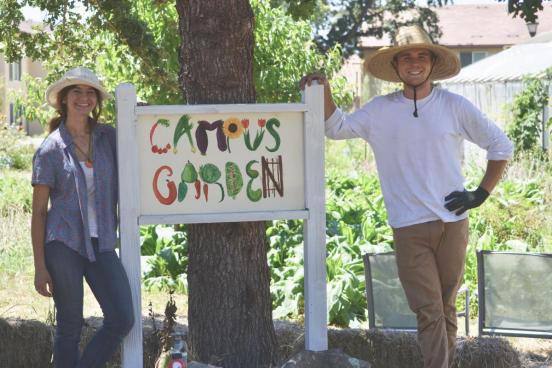 photo of students at "campus garden" sign
