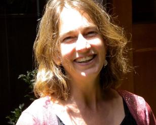 photo of person with shoulder length, light brown hair, smiling at camera