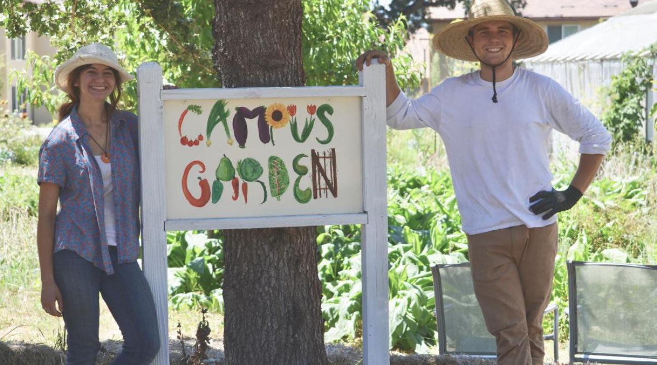 photo of students at "campus garden" sign