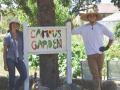 photo of students at "campus garden" sign