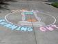 sidewalk chalk art displaying hourglass and words time is running out