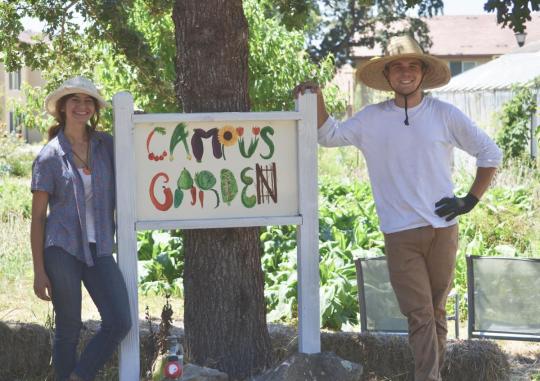 photo of students at "campus garden" sign