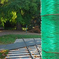 outdoor sculpture of railroad tracks and glass obelisque